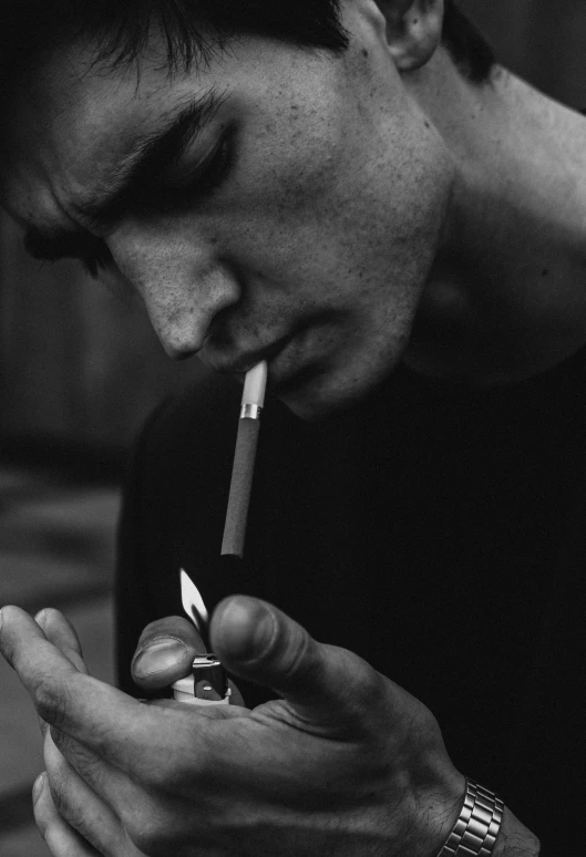 a black and white photo of a man smoking a cigarette, tumblr, thin young male, lowres, about to consume you, ansel ]