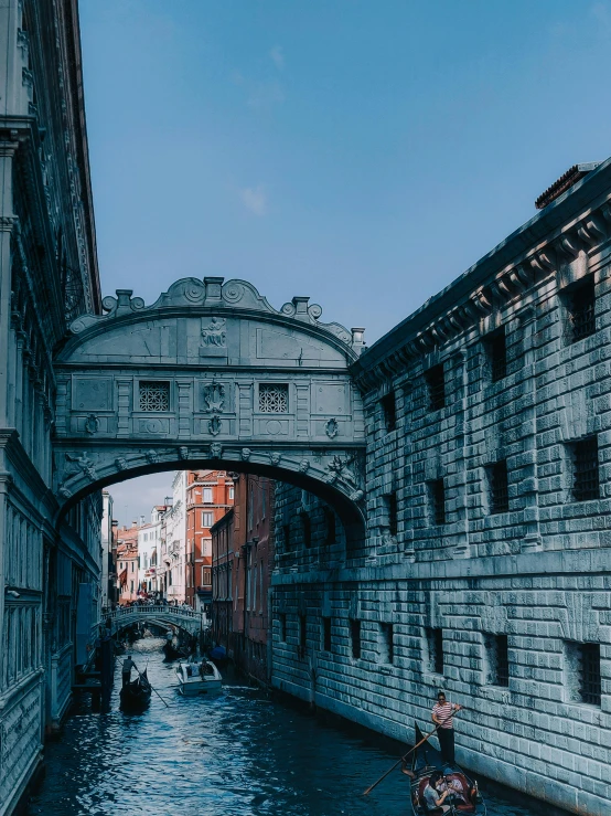 a man riding a boat down a river under a bridge, by Julia Pishtar, pexels contest winner, renaissance, indigo! and venetian red!, highly detailed in 4k”, white stone arches, ancient”