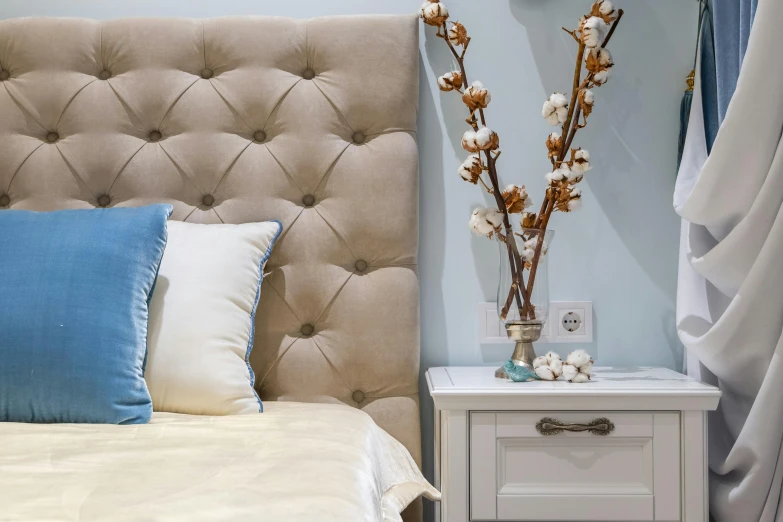 a bed room with a neatly made bed and a night stand, by Adam Marczyński, trending on pexels, rococo, cream and blue color scheme, tufted softly, thumbnail, brown and white color scheme