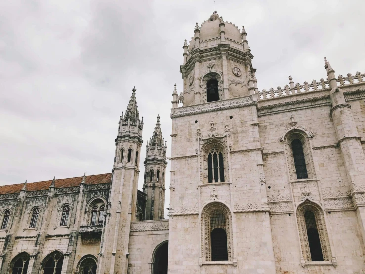 a couple of people that are standing in front of a building, pexels contest winner, neoclassicism, alabaster gothic cathedral, brutalist buildings tower over, college, lisbon