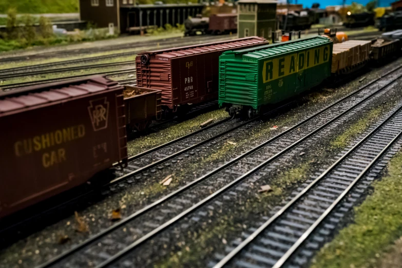 a close up of a train on a train track, a tilt shift photo, by Arnie Swekel, unsplash, photorealism, boxcar on the railroad, replica model, 2000s photo, detail shots