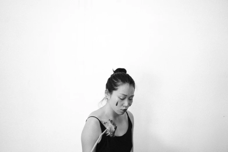 a black and white photo of a woman in a yoga pose, a black and white photo, inspired by Fei Danxu, tumblr, minimalism, portrait of a crying ai artist, holding a flower, white background : 3, kakar cheung