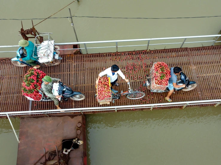 a group of people riding on top of a boat, inspired by Steve McCurry, pexels contest winner, dragon fruits, bridge, people shopping, top-down shot