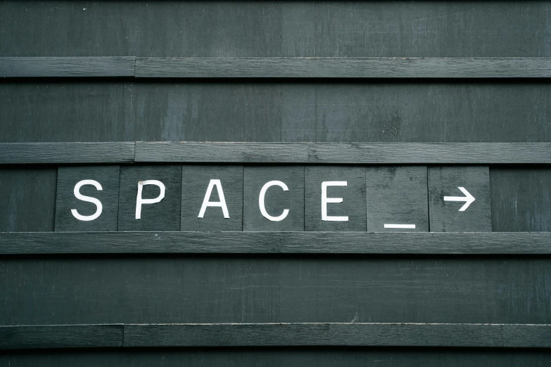 a close up of a sign on the side of a building, trending on unsplash, light and space, room of a spacecraft, square, a wooden, darkslategray wall