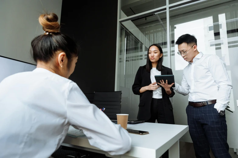 a group of people standing around a white table, on a desk, profile image, darren quach, office cubicles