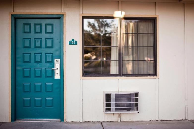 a red fire hydrant sitting in front of a blue door, by Ryan Pancoast, modernism, hotel room, teal, quaint, eichler home