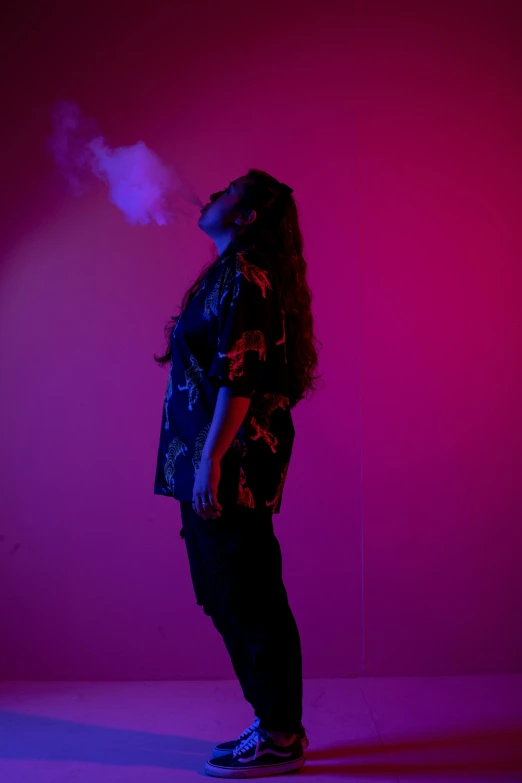 a woman standing in front of a pink wall, an album cover, pexels, marijuana smoke, shot at dark with studio lights, profile pose, asher duran