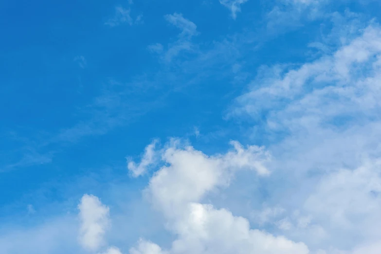 a plane flying through a cloudy blue sky, by Carey Morris, pexels contest winner, minimalism, cloudless blue sky, looking upward, today\'s featured photograph 4k, cloud day