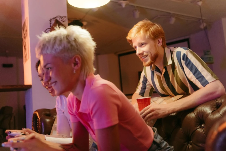 a man and a woman playing a video game, pexels, happening, college party, striped, a blond, group sit at table