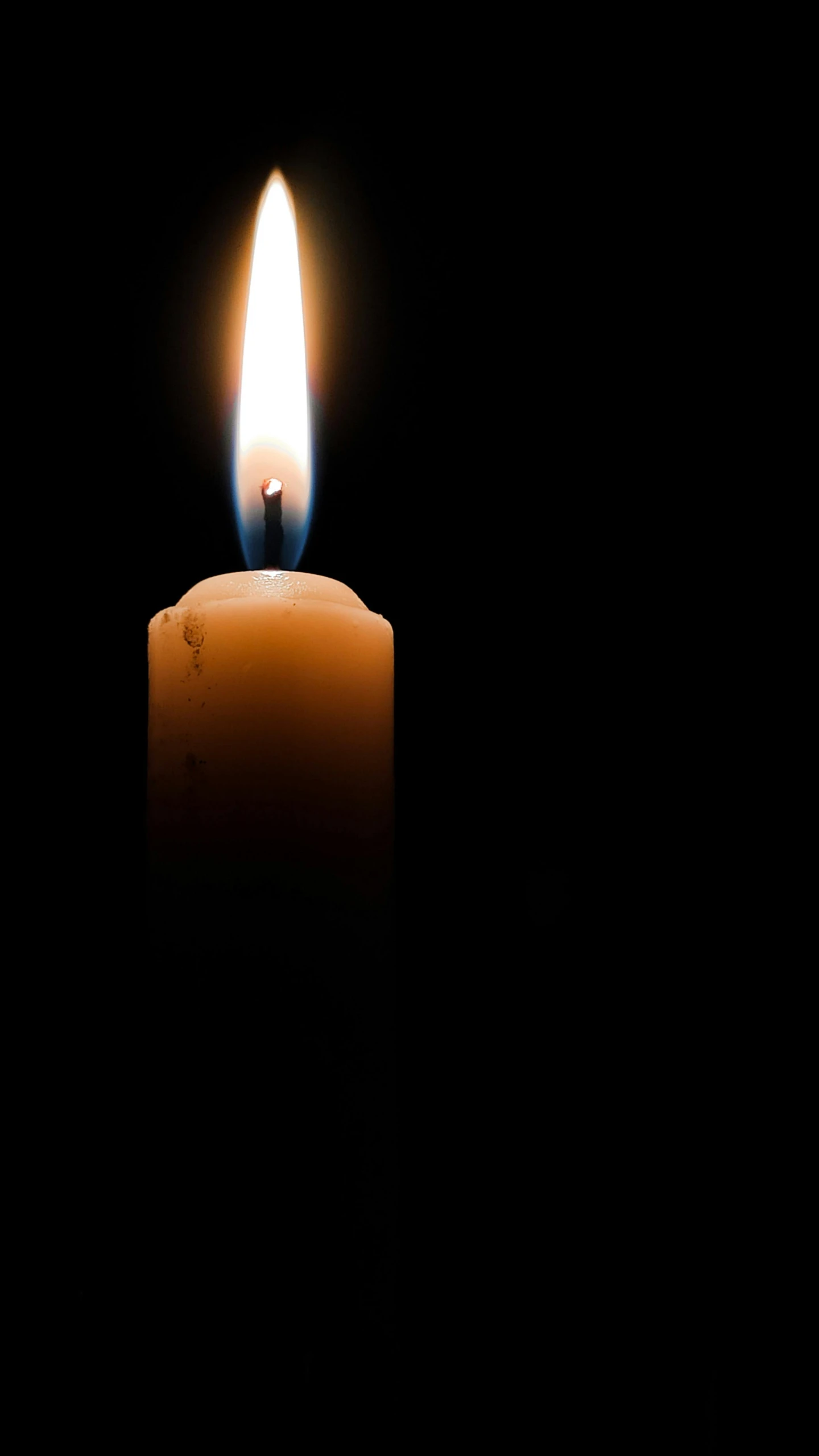 a single candle is lit in the dark, by John Murdoch, contain