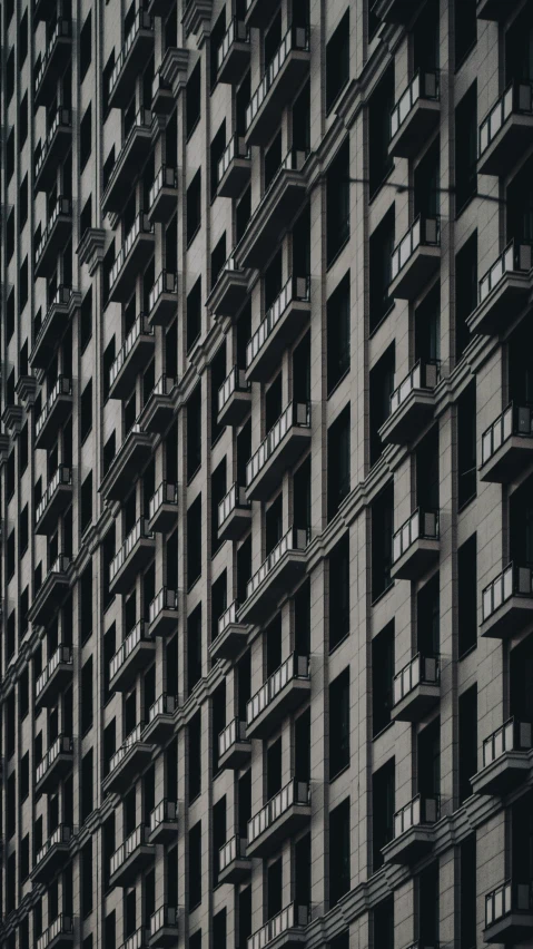 a black and white photo of a tall building, inspired by Andreas Gursky, pexels contest winner, brutalism, crenellated balconies, colour photograph, panel of black, neighborhood