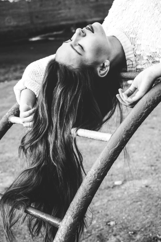 a black and white photo of a woman on a swing, pexels contest winner, long hair straight down, girl with super long hair, face down, hair : long brown