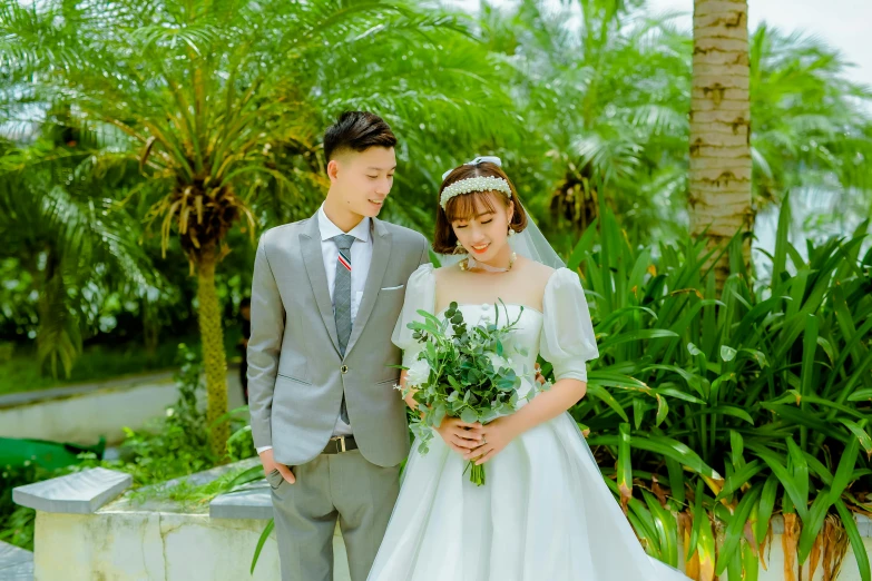 a bride and groom standing next to each other, a colorized photo, inspired by Kim Du-ryang, unsplash, green terrace, portrait shot 8 k, small, 中 元 节