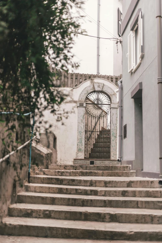 a man riding a skateboard down a set of stairs, pexels contest winner, art nouveau, circular gate in a white wall, french village exterior, streets of salvador, desaturated