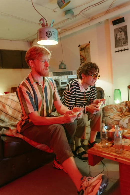 two men sitting on a couch playing a video game, by Lee Gatch, renaissance, summer evening, press shot, tall, show