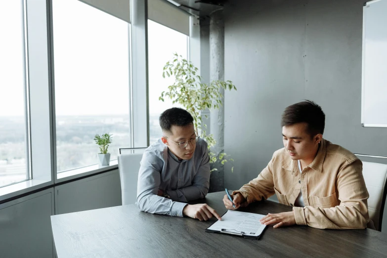 two men sitting at a table looking at a tablet, a cartoon, by Robbie Trevino, pexels contest winner, hoang long ly, sitting in office, gif, serious