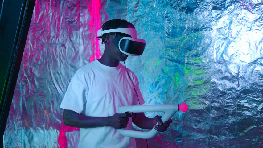 a man in a white shirt holding a water gun, inspired by David LaChapelle, unsplash, afrofuturism, using a vr headset, futuristic room, with neon visor, a teen black cyborg