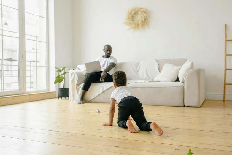 a man sitting on top of a wooden floor next to a child, white l shaped couch, without text, inspect in inventory image, playing