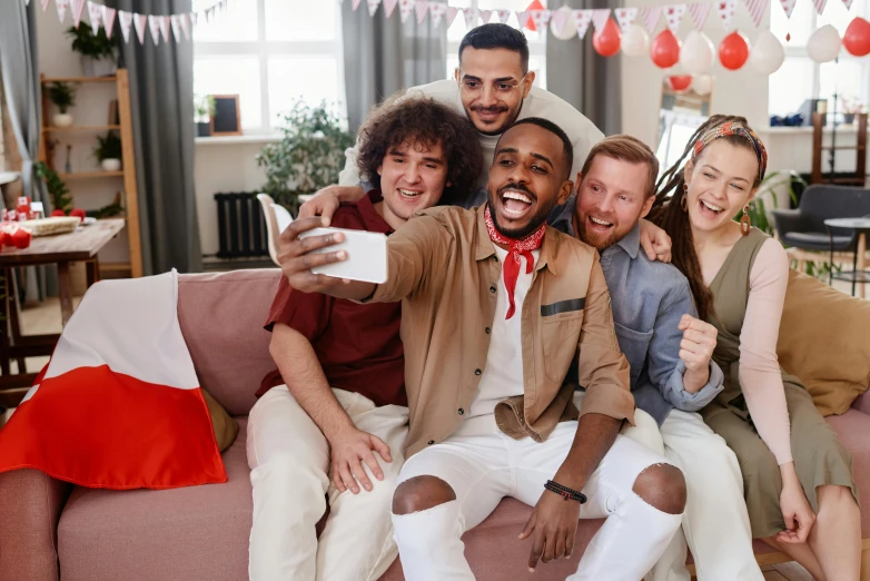 a group of people sitting on top of a couch, a picture, taking a selfie, red white and black, loveable guy, a still of a happy