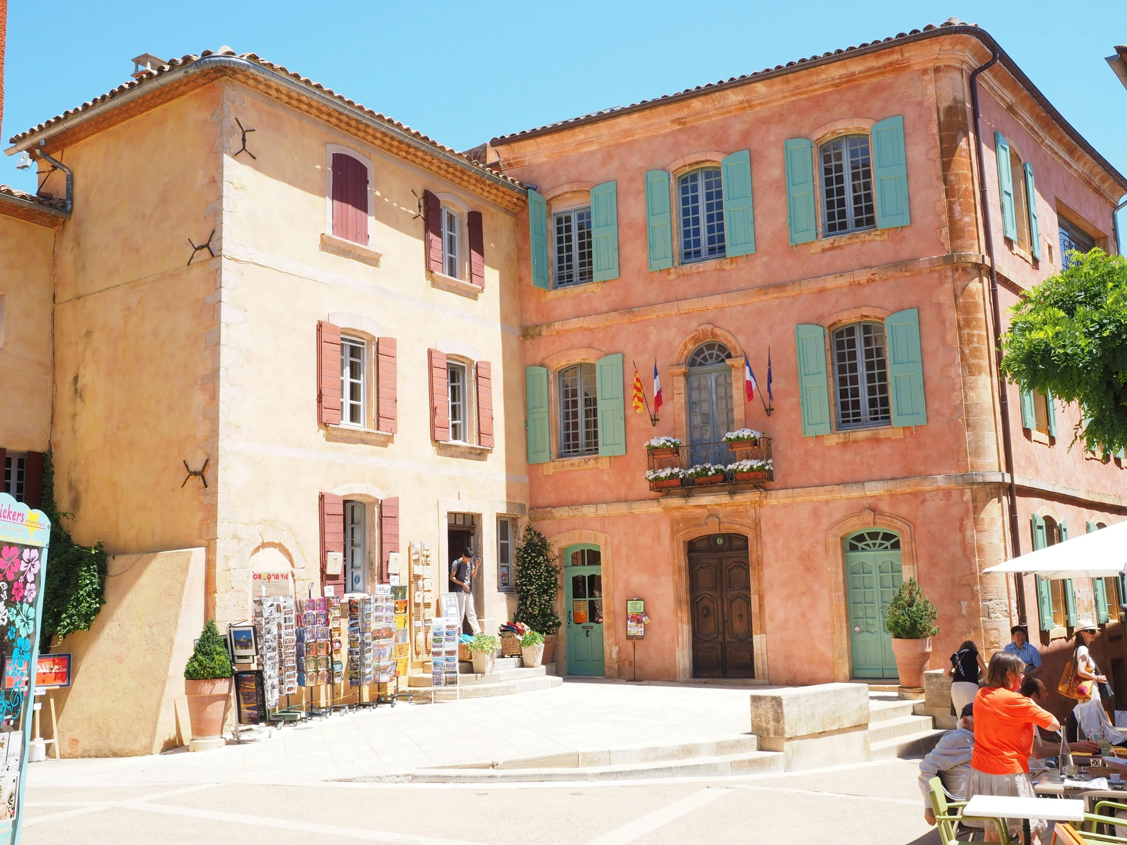 a group of people sitting at tables in front of a building, les nabis, ancient ochre palette, mauve and cyan, square, cloicsonne