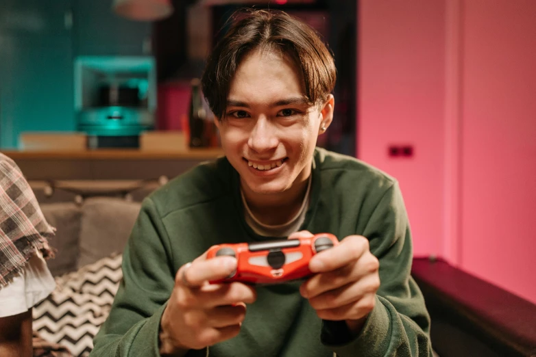 a young man holding a nintendo wii game controller, pexels contest winner, portrait of apex legends, teenager hangout spot, avatar image, playful smile