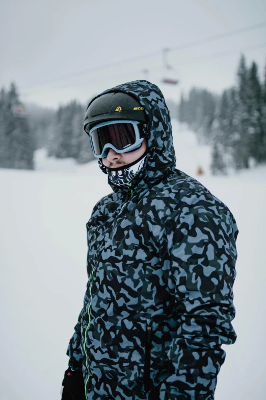 a man standing on top of a snow covered ski slope, pexels contest winner, graffiti, camouflage uniform, dark visor covering face, wearing a track suit, avatar image