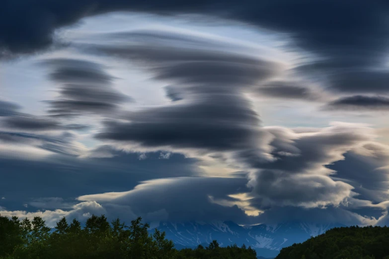 a group of clouds that are in the sky, a portrait, by national geographic, unsplash contest winner, alaska, strange formations, ben ridgway, turbulence