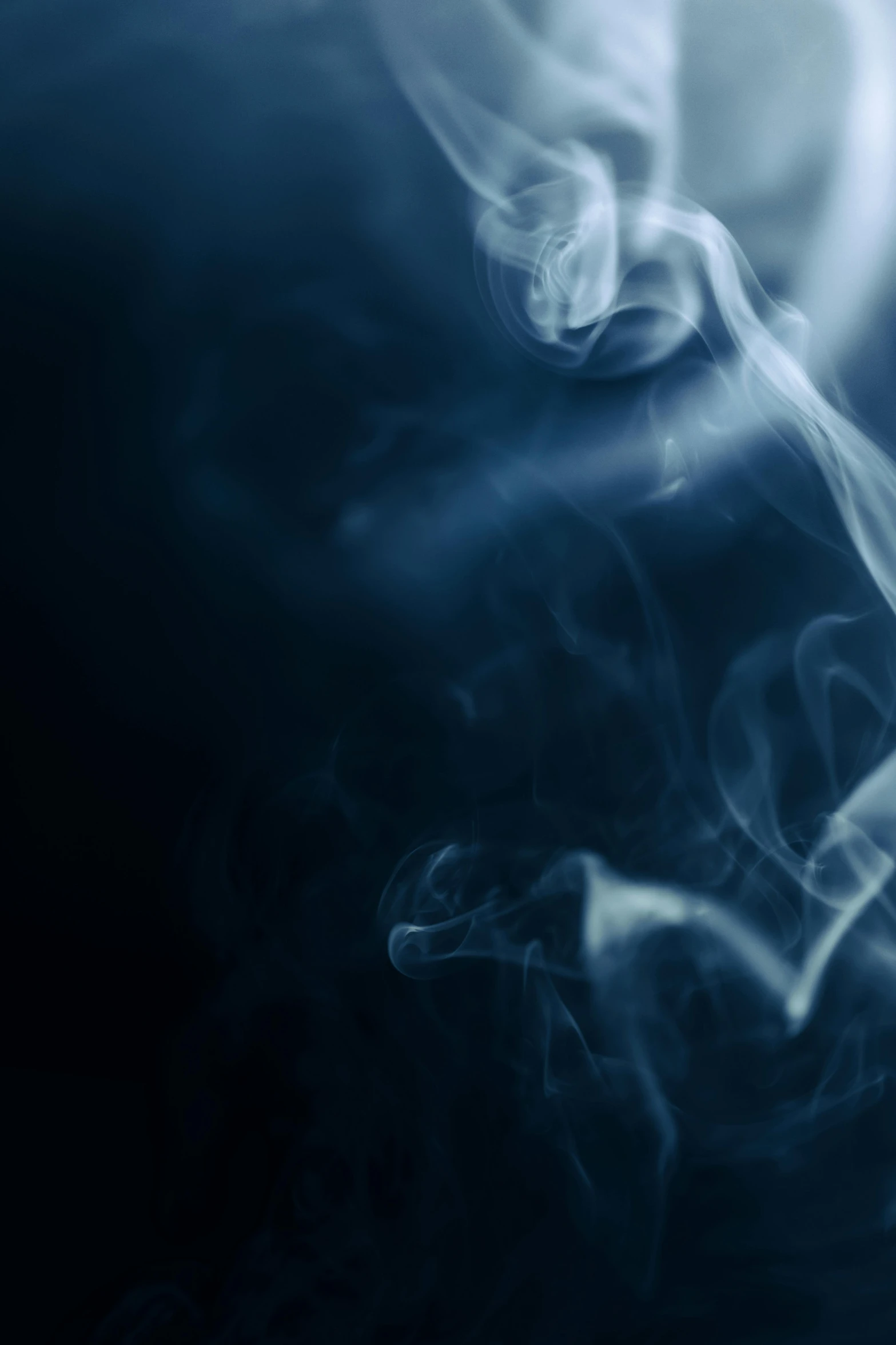 a close up of smoke on a black background, an album cover, pexels contest winner, blue soft light, spirits, desaturated blue, weed background