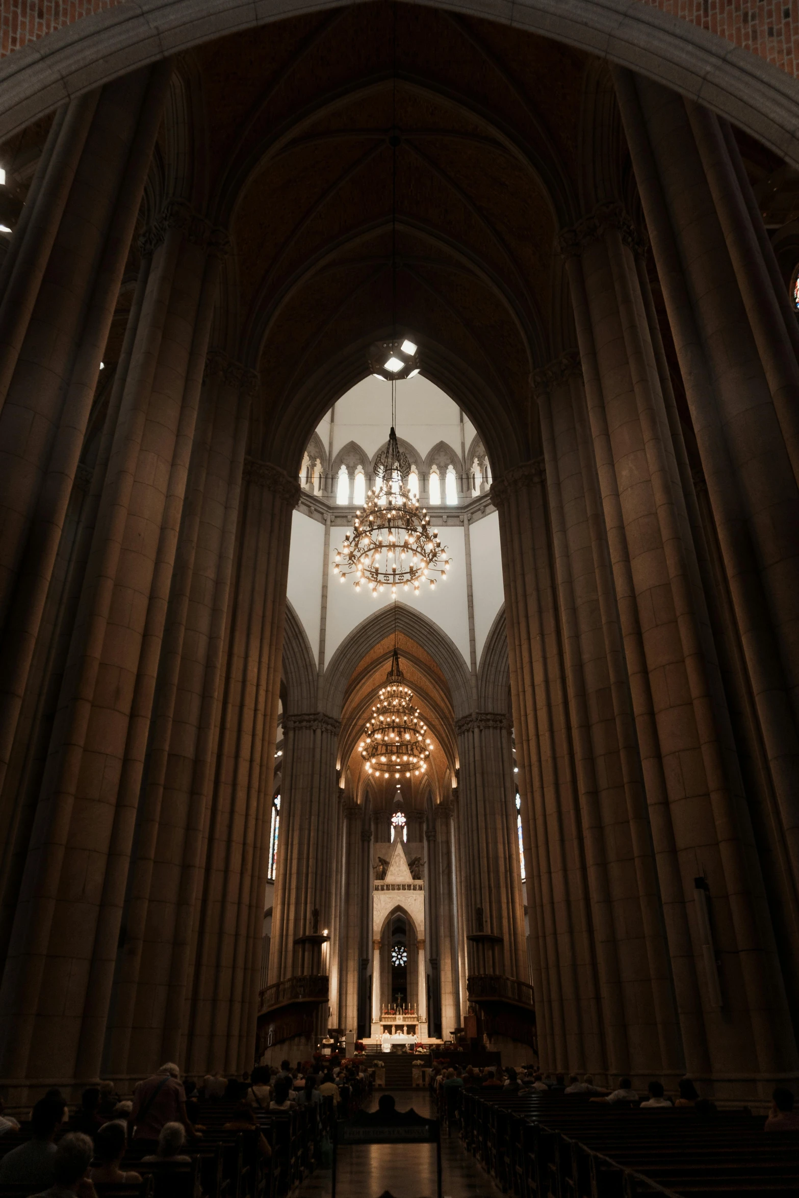 a large cathedral filled with lots of people, inspired by Barthélemy d'Eyck, unsplash contest winner, volumetric interior lighting, reykjavik, chandeliers, high details!