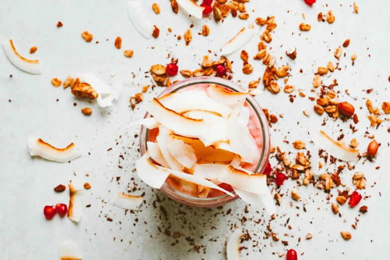 a glass filled with ice cream and nuts, a portrait, trending on unsplash, coconuts, red and white color theme, flowy, cosmopolitan