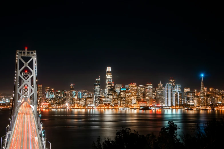 a bridge over a body of water with a city in the background, by Joseph Severn, pexels contest winner, hurufiyya, city neon light, background image, sf, full frame image