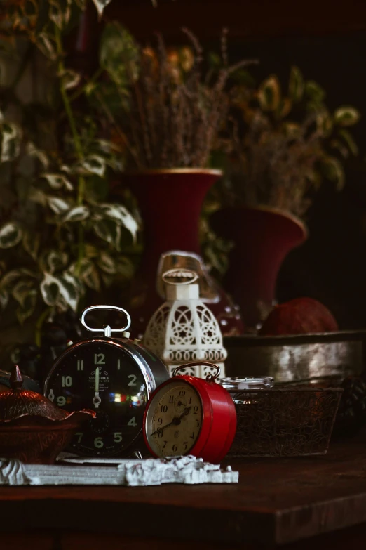 a clock sitting on top of a wooden table, a still life, inspired by Elsa Bleda, fine art, crimson themed, bells, holiday season, a cozy