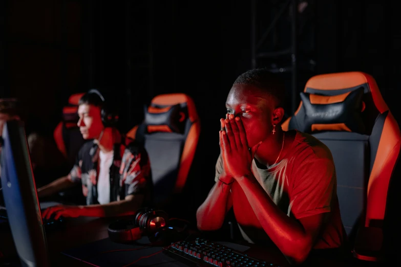 a man sitting at a desk in front of a computer, pexels, realism, twins playing video games, 2 rappers on stage at concert, facepalm, ismail inceoglu and ruan jia