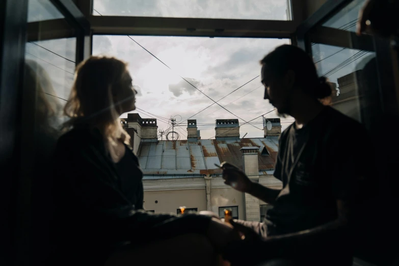 a man and a woman sitting in front of a window, by Emma Andijewska, pexels contest winner, happening, rooftop, instagram picture, moscow metro, profile image