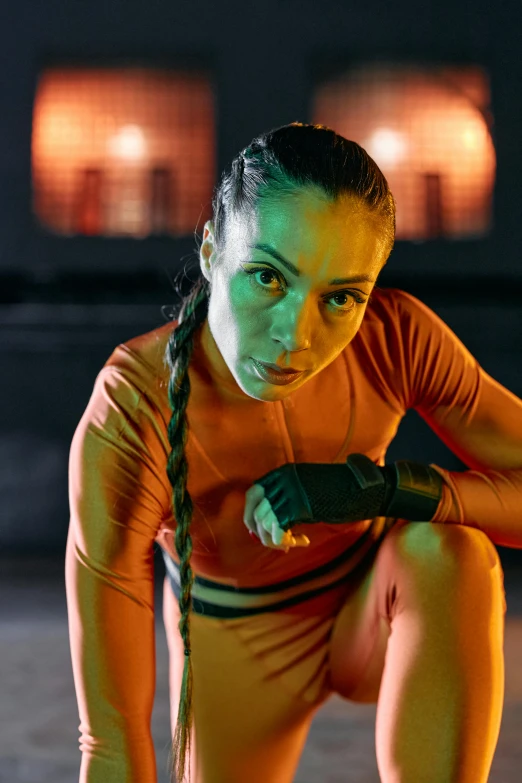 a woman squatting on a skateboard in the dark, a portrait, pexels contest winner, antipodeans, wearing orange prison jumpsuit, chappie in an adidas track suit, wearing vibrant boxing gloves, wearing futuristic clothing