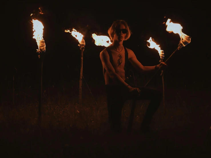 a woman holding torches in a field at night, an album cover, pexels contest winner, beth cavener, skinny male magician, fireballs, profile image