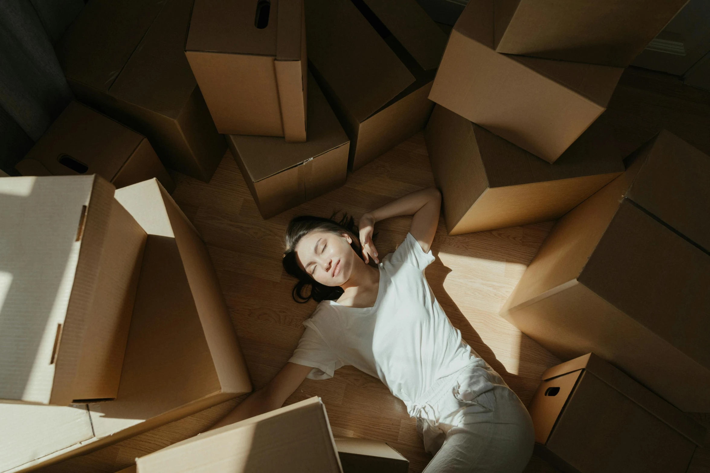 a woman laying on the floor surrounded by boxes, by Emma Andijewska, pexels contest winner, renaissance, avatar image, animation, asian female, cinematic outfit photo