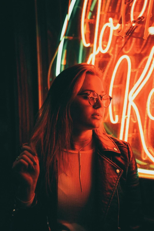 a woman standing in front of a neon sign, inspired by Elsa Bleda, pexels contest winner, girl with glasses, handsome girl, ellie bamber, at a bar