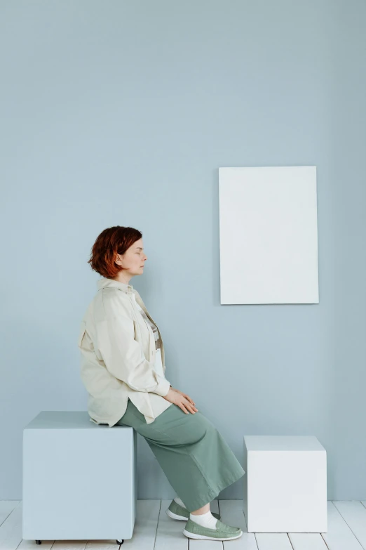 a woman sitting on top of a white cube, a minimalist painting, sophia lillis, in muted colours, reflecting, profile image