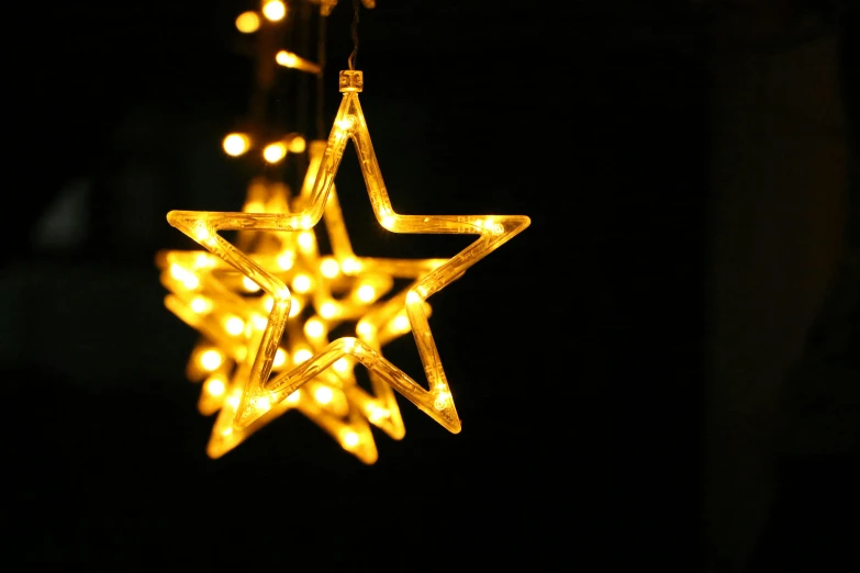a string of lights in the shape of a star, pexels, taken with sigma 2 0 mm f 1. 4, shiny golden, low detail, rectangle