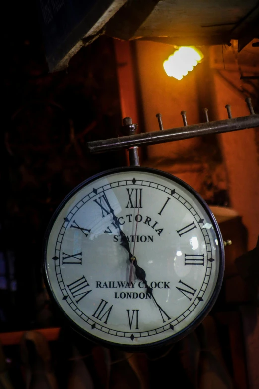 a clock hanging from the side of a building, victorian harbour night, a steampunk store, indoor picture, thumbnail