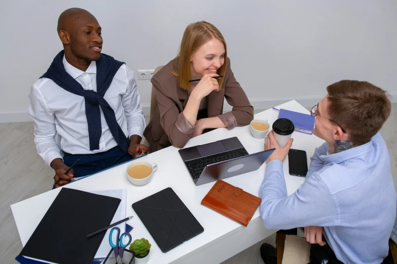 a group of people sitting around a table with laptops, pexels contest winner, office clothes, professional profile picture, thumbnail, unedited