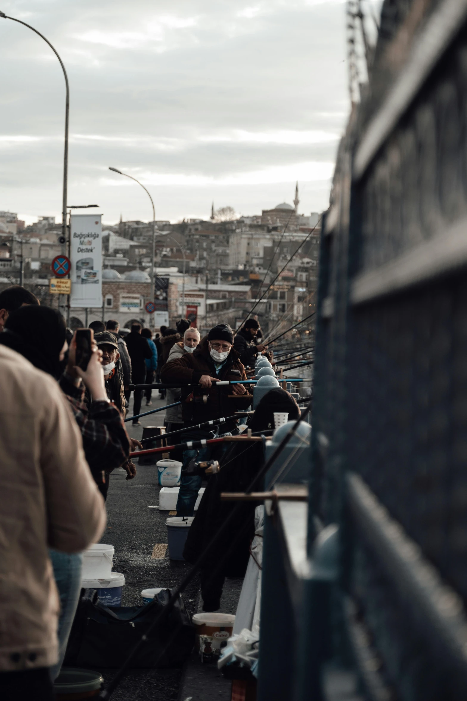 a group of people standing on top of a bridge, istanbul, barriers, standing in a township street, instagram post