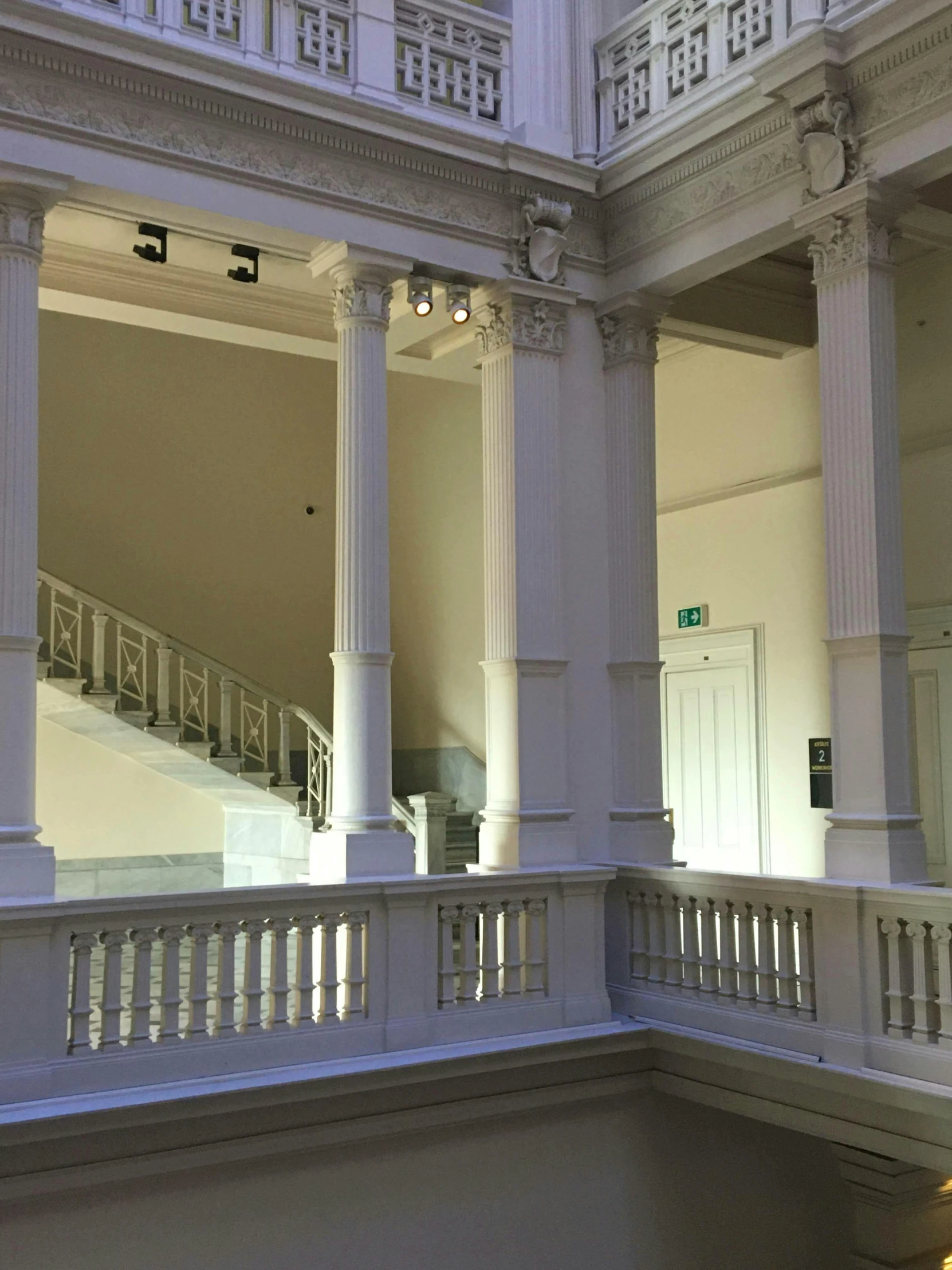 a clock that is on a pole in a building, a marble sculpture, light and space, wide grand staircase, national art school mfa, rembrandt lighting scheme, marble white columns