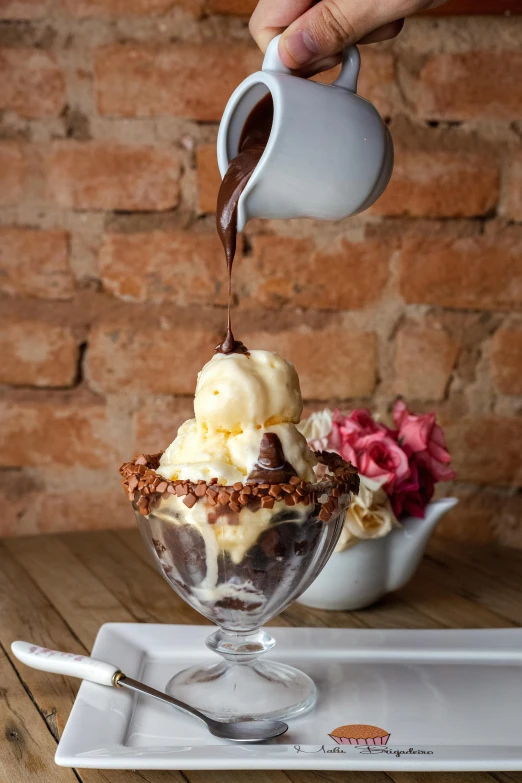 a person pouring chocolate into a bowl of ice cream, floral, bizzaro, rocky roads, brazilian