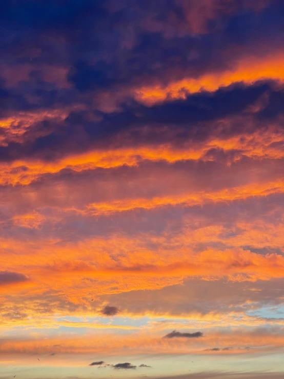 a large body of water under a colorful sky