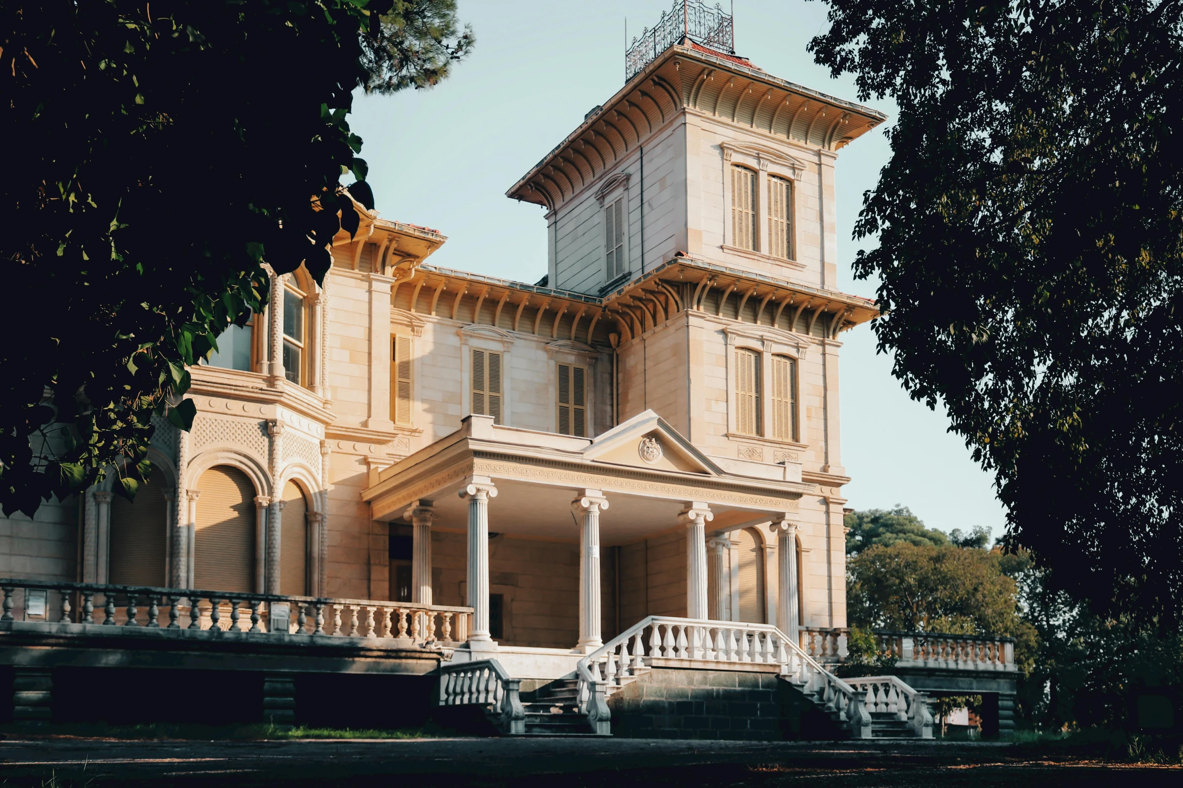 a large house sitting on top of a lush green field, a marble sculpture, inspired by Vincenzo Cabianca, pexels contest winner, style of wes anderson, exterior view, museum photo, porches