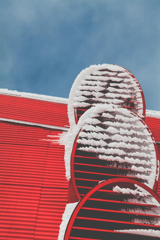 a fire hydrant covered in snow next to a red building, a photo, pexels contest winner, conceptual art, windmills, contrails, roof with vegetation, fenway park