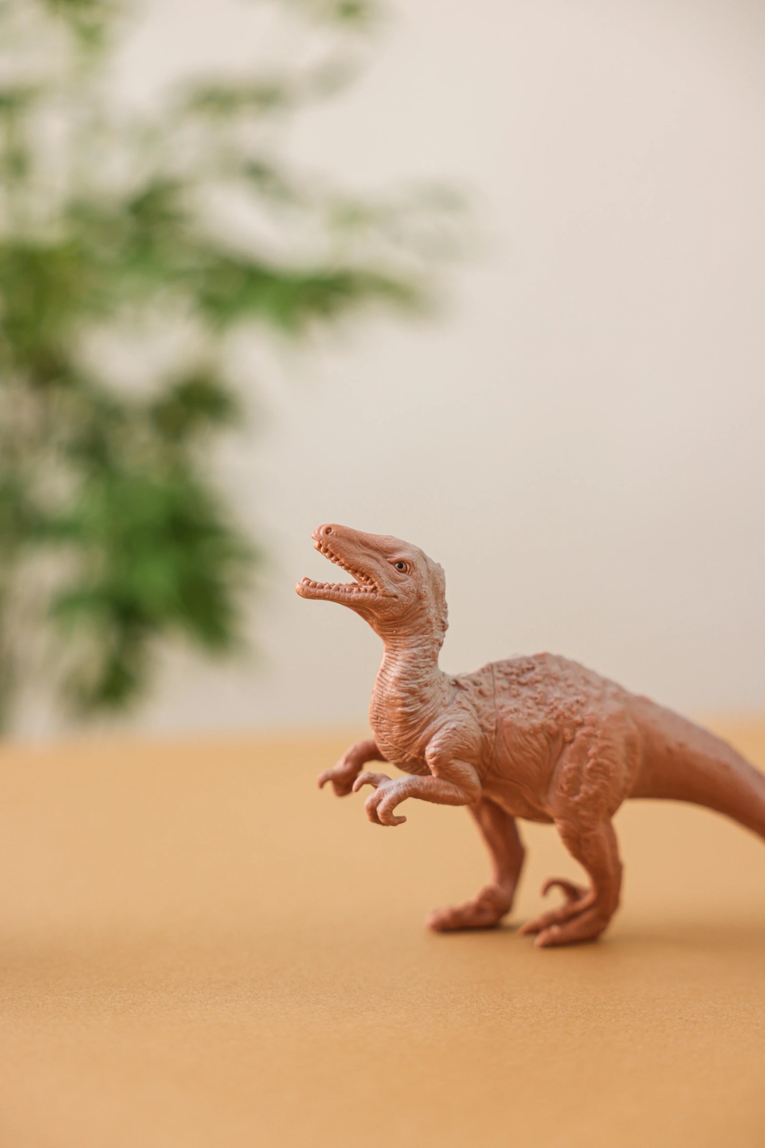 a close up of a toy dinosaur on a table, inspired by Adam Rex, trending on unsplash, figuration libre, realistic »