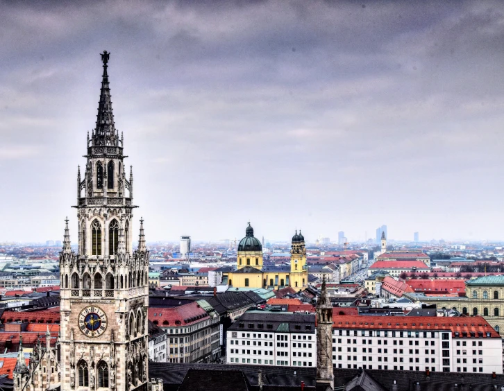 a large clock tower towering over a city, a colorized photo, by Kristian Zahrtmann, pexels contest winner, baroque, munich, black domes and spires, ultrawide lens”, square